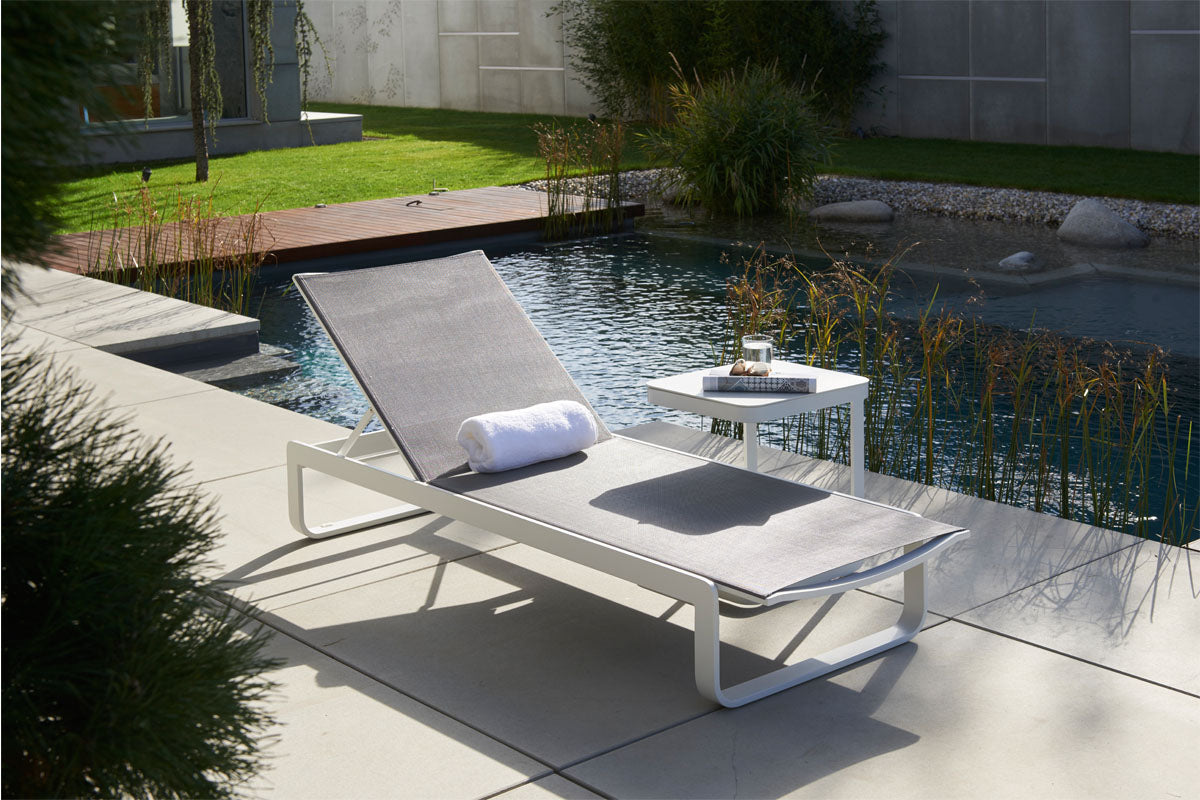 Bain de soleil en aluminium haut de gamme avec toile en textilène gris, structure blanche à peinture époxy élégante.