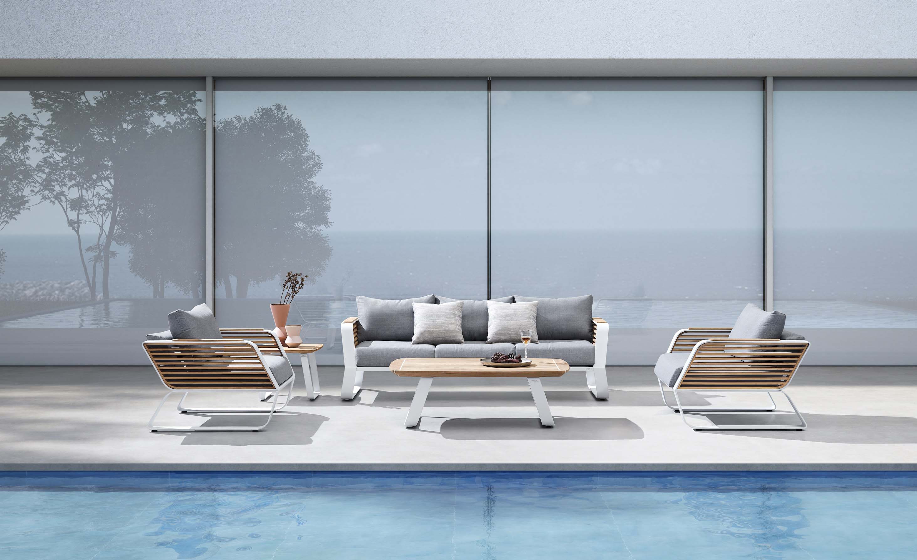 Salon de jardin haut de gamme en aluminium léger et teck FSC, design luxueux Pininfarina avec canapés 3 places et coussins.
