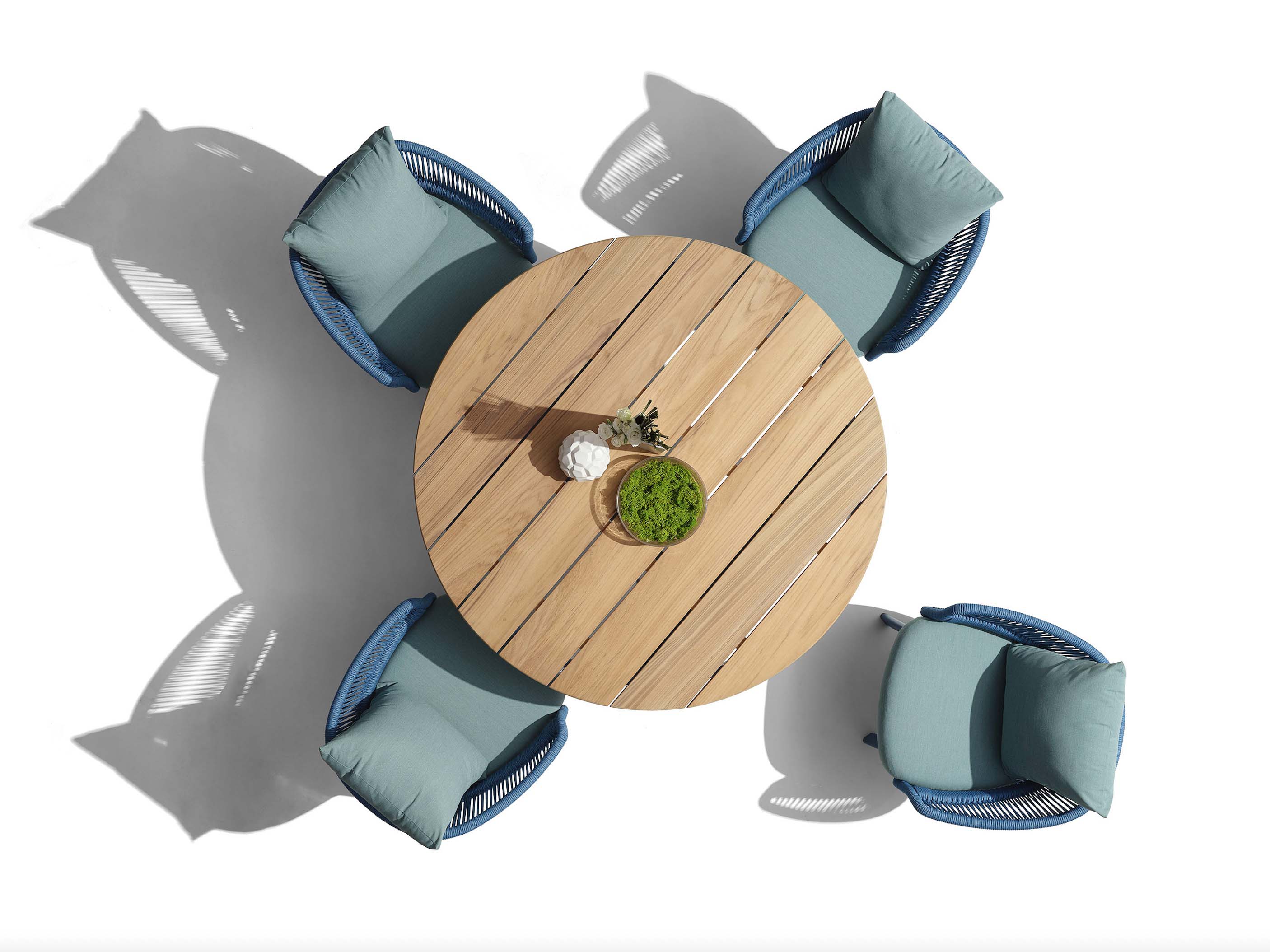 Ensemble repas haut de gamme en aluminium et corde tressée, table ronde en Teck FSC, chaises bleu clair avec coussins.