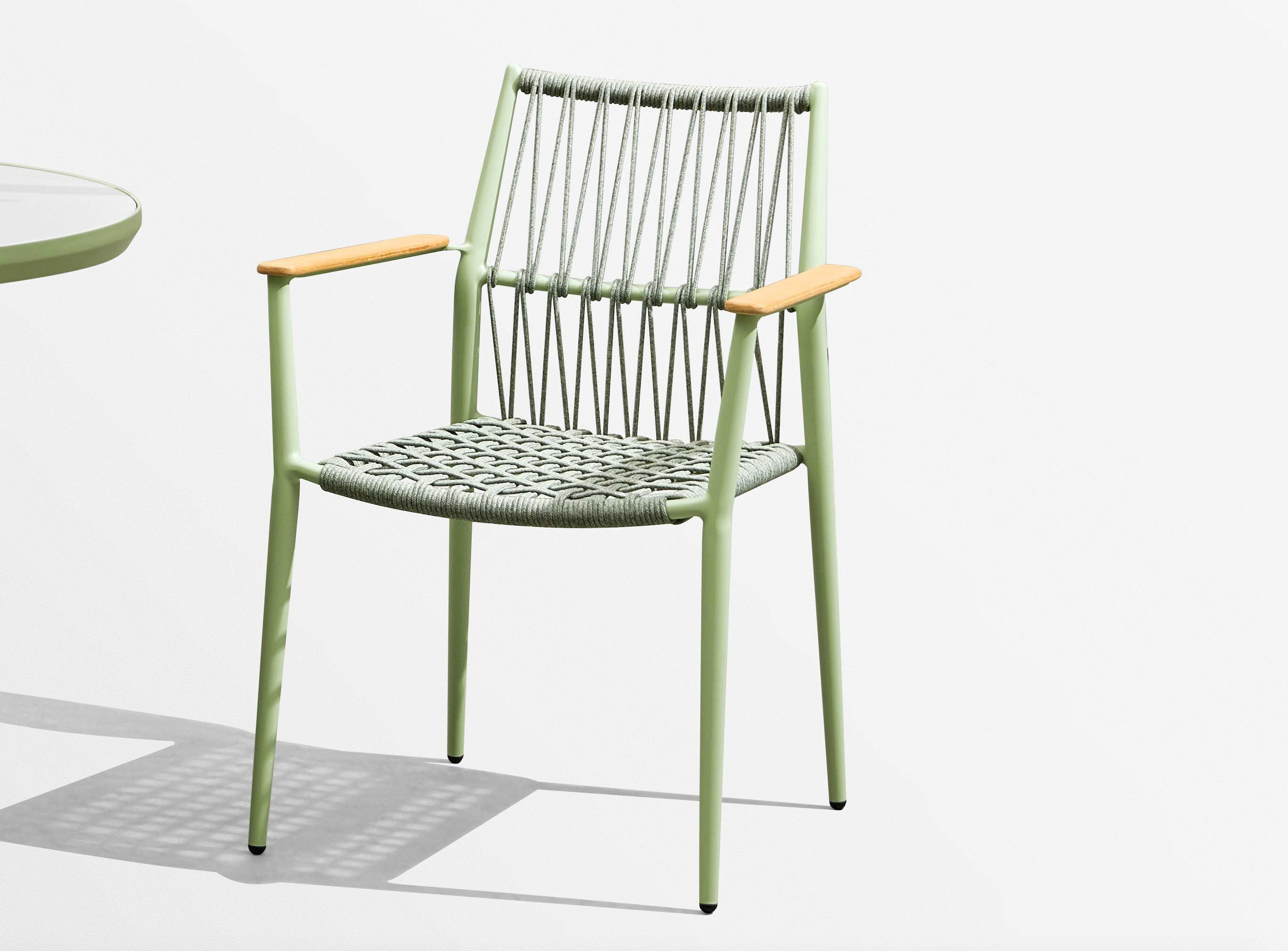 Chaise bistrot haut de gamme en aluminium vert, accoudoirs en bois, design élégant et durable pour terrasse de restaurant.